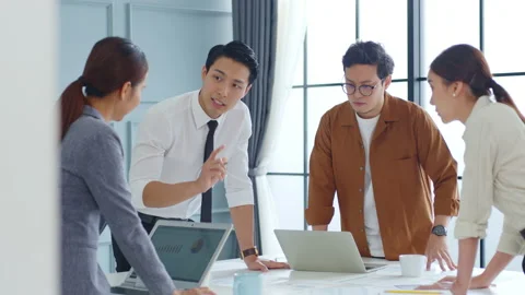 Group of young Asian business people meeting and brainstorming in office Stock Footage