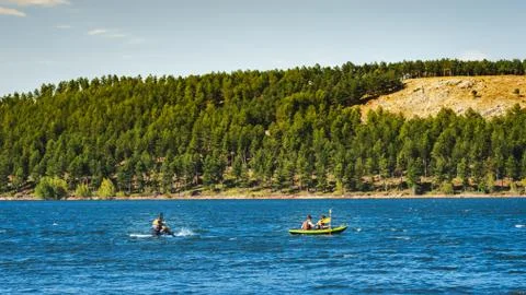 Group of young athletic explorers in their kayaks canoeing and enjoying the t Stock Photos