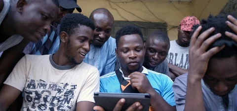 Group of young black men checking a mobile device Stock Footage 105376965