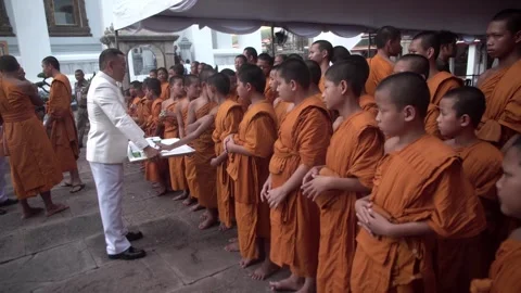 A group of young Buddhist monks attend a Buddhist ceremony Stock Footage 342423428