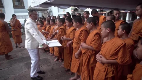 A group of young Buddhist monks attend a Buddhist ceremony Stock Footage 342423761