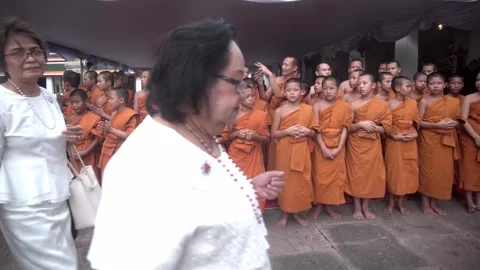A group of young Buddhist monks attend a Buddhist ceremony Stock Footage 342424412