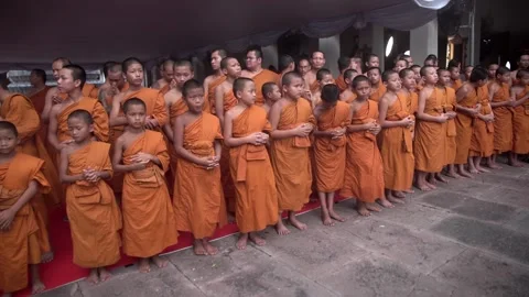 A group of young Buddhist monks attend a Buddhist ceremony Stock Footage 342435676