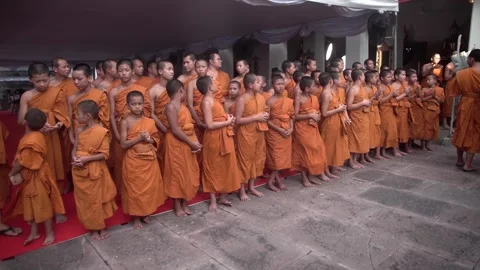 A group of young Buddhist monks attend a Buddhist ceremony Stock Footage 342437402