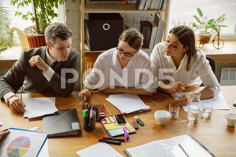 Group Of Young Business Professionals Having A Meeting, Creative Office