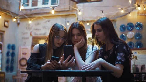 Group of young Caucasian students sitting at table with smartphones in hands Stock Footage 95919692
