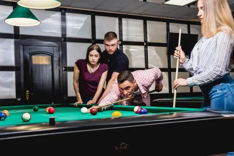 Friends play billiards., Stock image