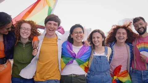 Group of young cheerful friends strolling together on day of gay pride parade in 스톡 동영상 240202208