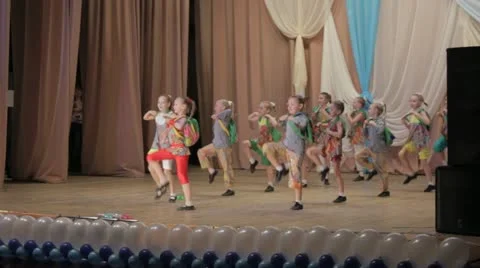 Group of young children performing a dance on stage Stock Footage 21711796
