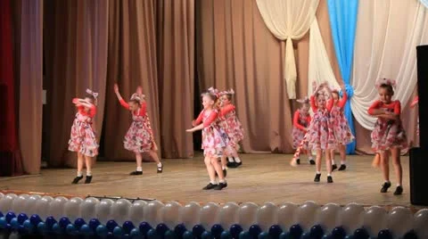 Group of young children performing a dance on stage Stock Footage 21726724