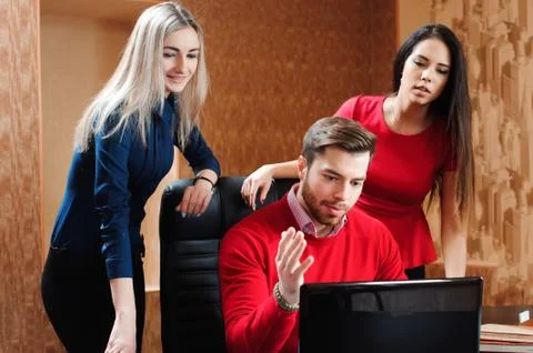 Group of young colleagues using laptop at office Stock Photos