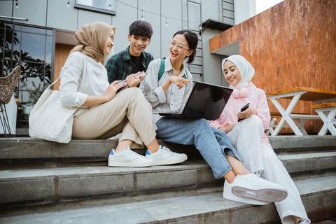 Group of young college students using laptops on the steps Stock Photos