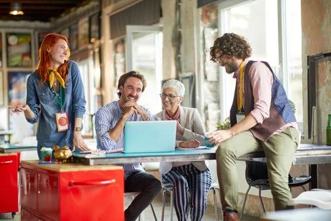 Group of young creative employees is having a good time with their female bos Stock Photos