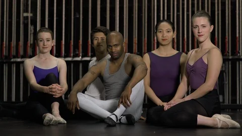 Group of young dancers sitting together on stage looking at camera. 動画素材 88037819