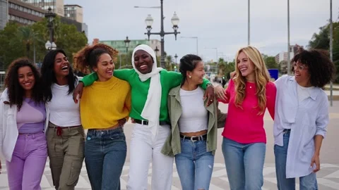 Group young diverse friends walking relaxed and talking to each other and Stock Footage 274456569