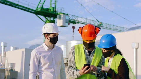 Group of young diverse specialists in construction site at the end of the day in Stock Footage 143157890