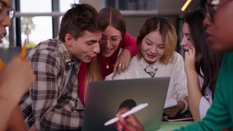 Group of young diverse students people laughing using laptop in the cafeteria on Stock Footage 271070095