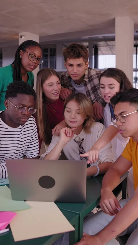 Group of young diverse students people laughing using laptop in the cafeteria on Stock Footage 273000681