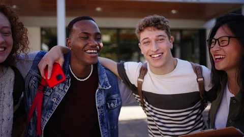 Group young diverse students standing hugging looking laughing at camera outside Stock Footage 316966736
