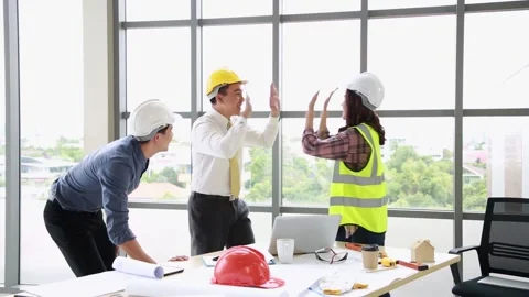 Group of young engineers team giving high five and celebrating success at off Stock Footage 171257783