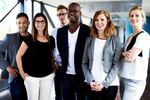 Group of young executives posing for picture Stock Photos