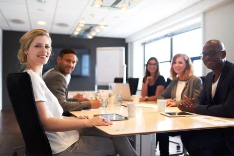 Group of young executives smiling at camera Stock Photos