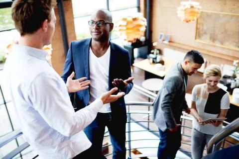 Group of young executives working on staircase Stock Photos