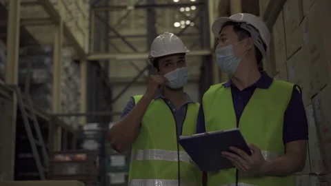 Group of young factory warehouse workers wearing a protective face mask while Stock Footage 140633542