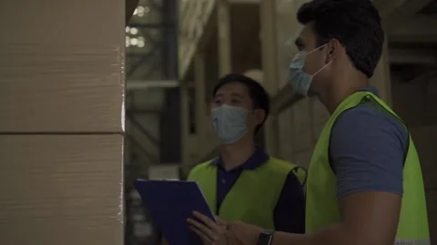 Group of young factory warehouse workers wearing a protective face mask while Stock Footage 140634929