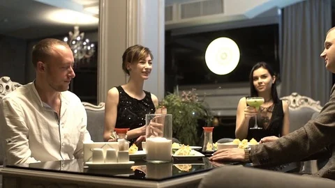 Group of young friends are having fun in the restaurant, drinking cocktails. Stock Footage 83650358