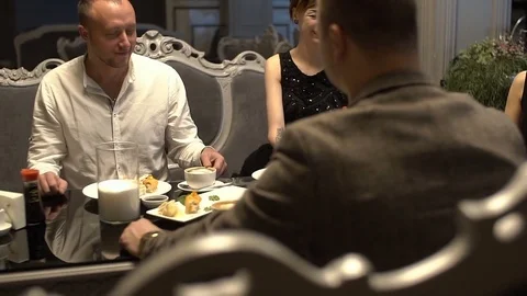 Group of young friends are having fun in the restaurant, drinking cocktails. Stock Footage 83650451