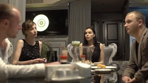 Group of young friends are having fun in the restaurant, drinking cocktails. Stock Footage 83650643