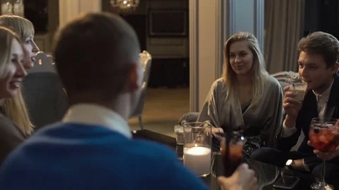 Group of young friends are having fun in the restaurant, drinking cocktails. Stock Footage 83650737