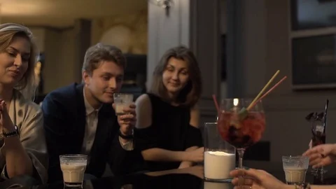 Group of young friends are having fun in the restaurant, drinking cocktails. Stock Footage 83650929