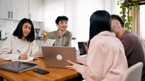 Group of young friends collaborating on project at home Stock Photos