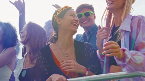 Group Of Young Friends Dancing Behind Barrier At Outdoor Music Festival  With Stock Footage 312679063