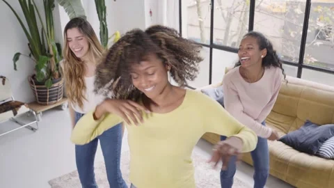 Group of young friends dancing fun at home. Cheerful trio of multiracial women Stock Footage 246770971