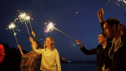 Group of young friends having a beach party. Friends dancing and celebrating Stock Footage