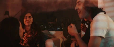Group of young friends having fun and eating pizza in moody lights Stock Footage 202265585