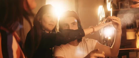 Group of young friends having fun with lights of vintage projector Stock Footage 202265872