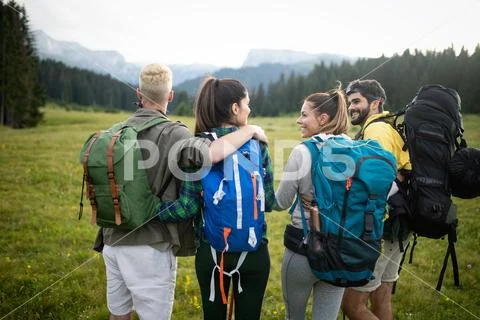 Group of young friends hiking in countryside. Multiracial young people on Stock Photos