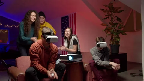 Group of young friends playing virtual videogame Stock Footage 147398118