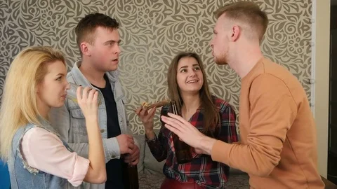 Group of young friends talking and flirting at a house party Stock Footage