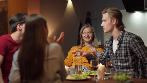 Group of young friends talking at dinner Stock Footage 114814030