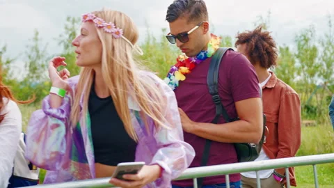 Group Of Young Friends Waiting Behind Barrier At Entrance To Music Festival Site Stock Footage 312676885