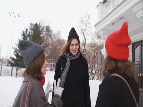 Group Of Young Friends Walking Through Street In Winter City Stock Footage 72485080