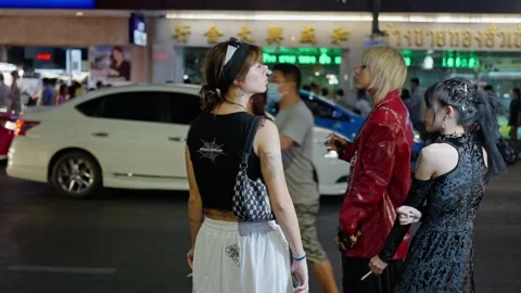 A group of young girls smoke while standing near a high-traffic road. 16. 04 Video stock 304754671