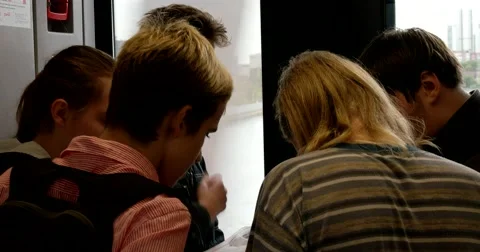 A group of young guys looking at maps in the train Stock Footage 67468869