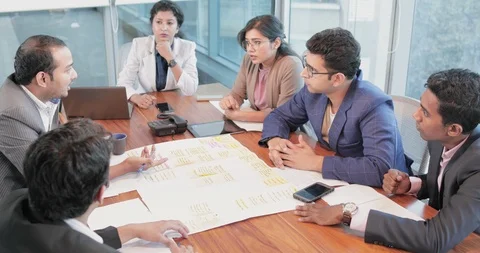 A group young Indian executives discussing in an office boardroom, India Stock Footage 88721147
