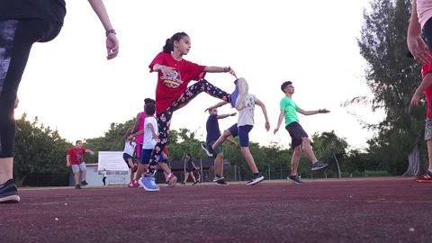 Group of Young Kids Doing Track and Field Leg Drills  4k Stock Footage 219592896